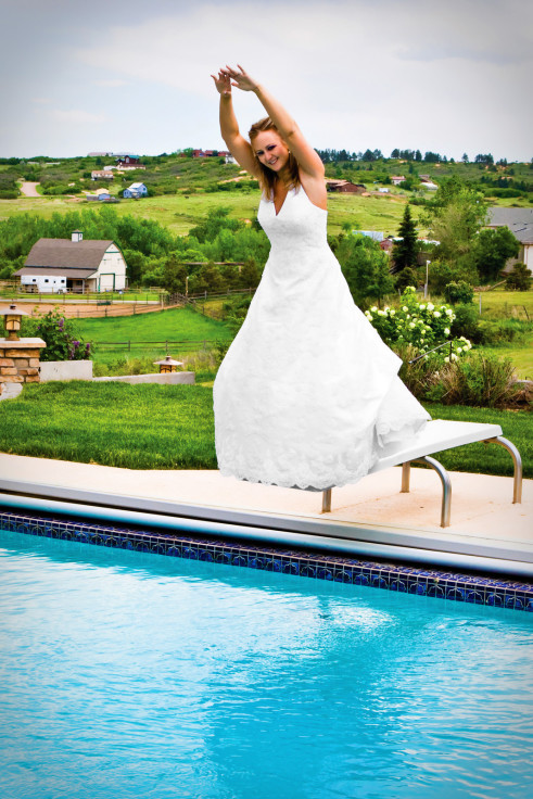 Bride jumping into pool on her wedding day - Mountain View Photo