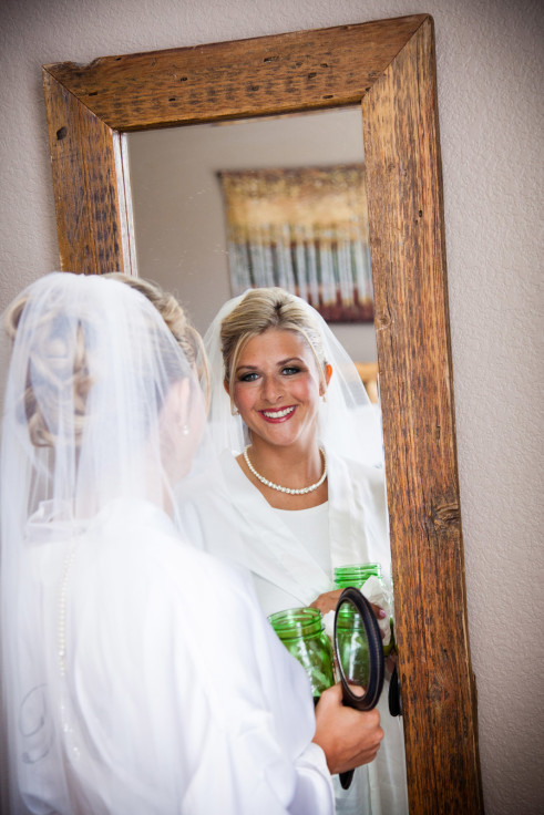 Bride posing in the mirror