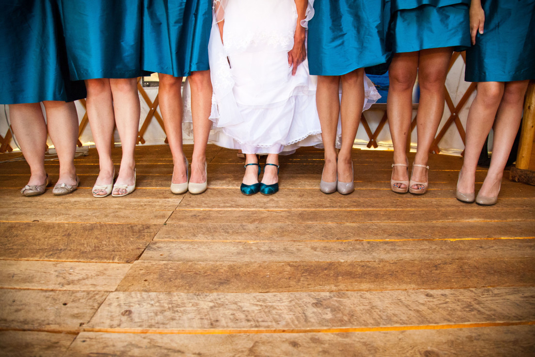 Bride with her bridesmaids showing shoes