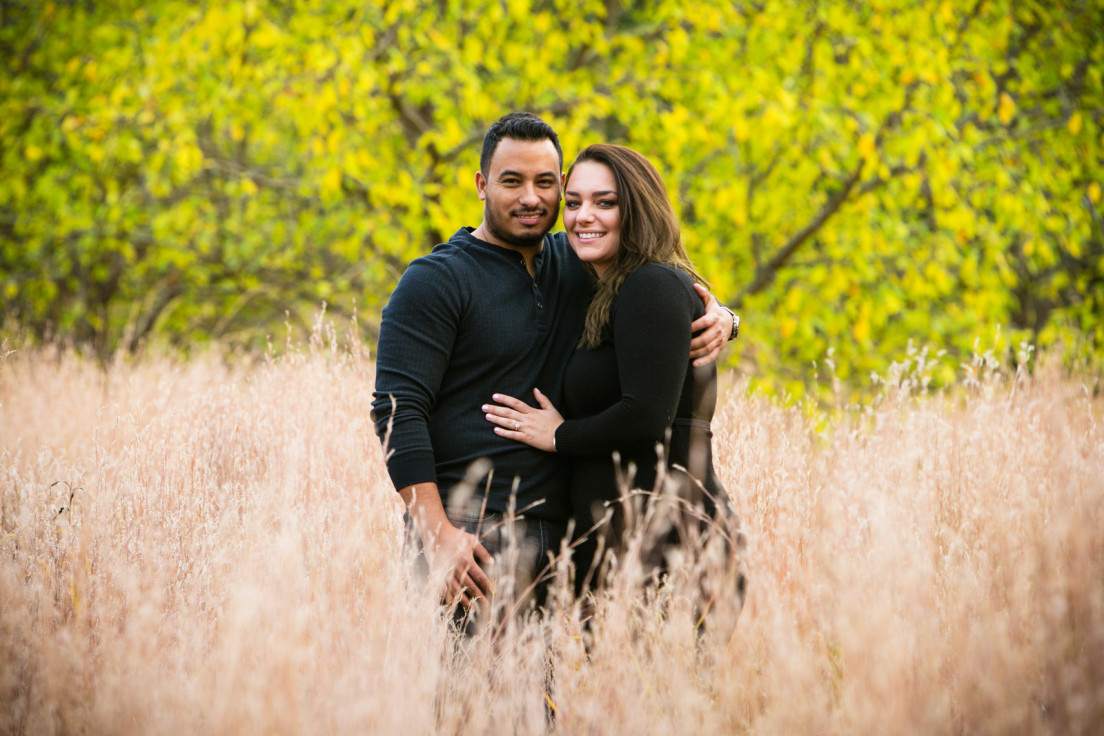 Couple smiling at their photographer